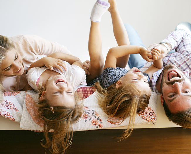 Familie auf Bett im Schlafzimmer